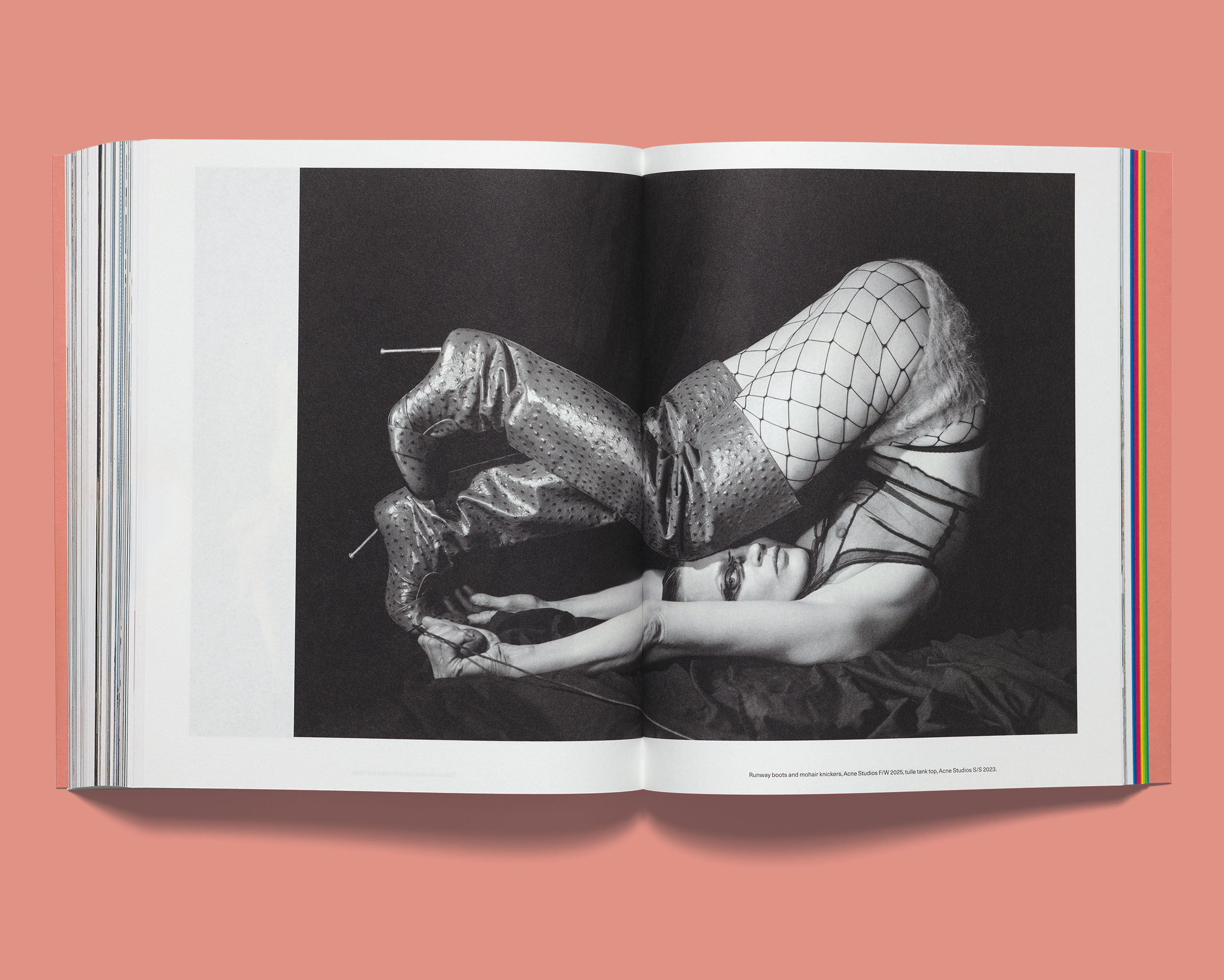 Open Acne Paper showing a black-and-white editorial photo of runway boots, mohair knickers, and tulle tank top styled together.